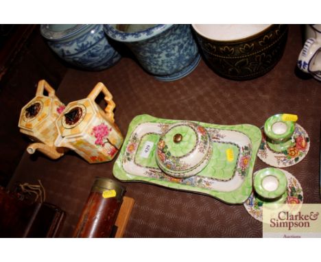 A Malingware four piece dressing table set and a pottery sun dial teapot and milkjug