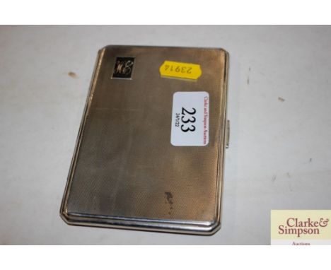 A silver engine turned cigarette case with monogram