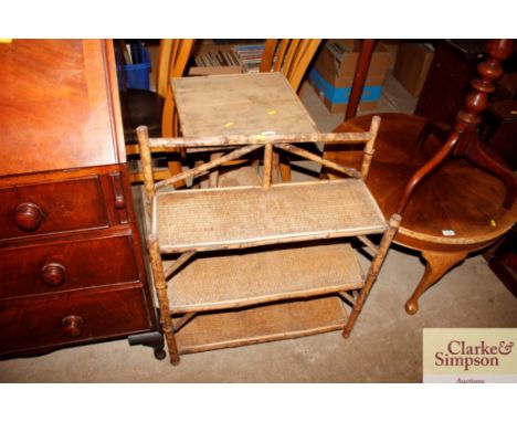 A bamboo and wicker three tier book shelf and a two tier occasional table