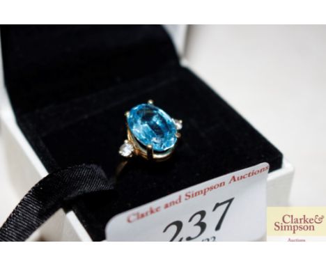 A gold and blue stone set ring