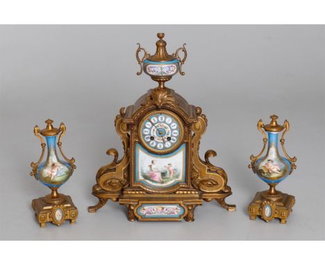 
	
		A French gilt metal and Sevres-style clock garniture, late 19th century, scrolling architectural case around painted dia