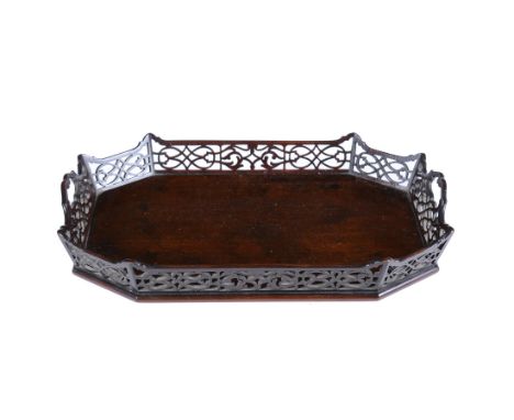 
	
		A small mahogany tray in the Chippendale Chinese manner, of elongated octagonal form, pierced fretwork gallery with twin