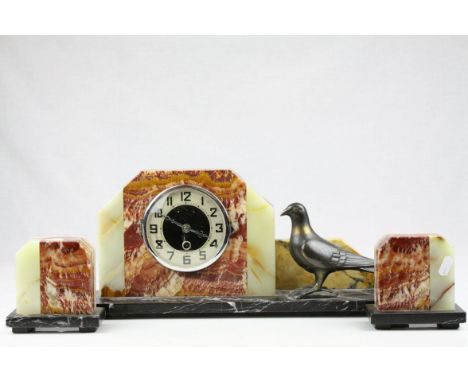Art Deco Clock Garniture constructed from Marble and Onyx, the clock mounted with a Spelter Pigeon, with key, clock 45cms lon