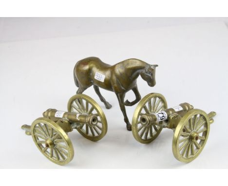 Two vintage brass cannons and a horse 
