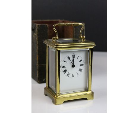 French Brass Cased Carriage Clock with Bevelled Glass Panels, the White Enamel Face with Roman Numerals, with key, 14cms high