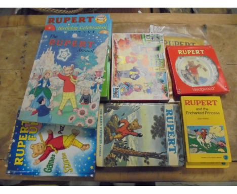 Box of Rupert Bear collectables including vintage annuals, puzzle and Wedgwood plate