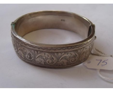 A wide scroll engraved silver hinged bangle 29g   