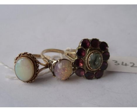 An antique garnet set ring and 2 opal rings    