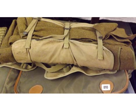 Modern suit bag carrier and Army blanket in canvas roll   