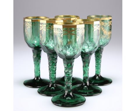 A RARE SET OF SIX BOHEMIAN GREEN AND GILDED WINE GLASSES, CIRCA 1790, the bowl of each with ten vertical panel cuts supported