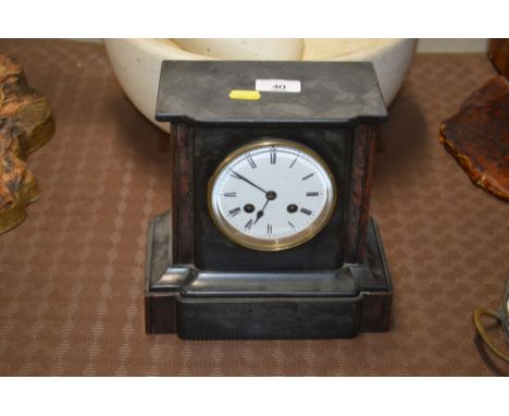 A late Victorian black slate and marble two hole mantel clock