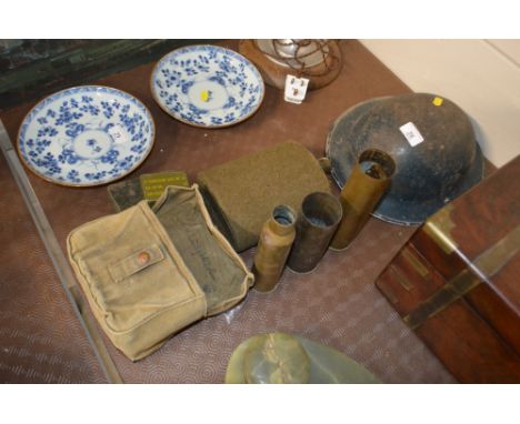 A World War II period tin helmet dated 1939, three brass shell cases, a water flask etc.