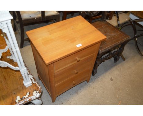 A modern light oak three drawer bedside chest 