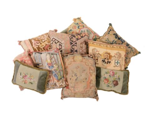  A collection of eight cushions  , including one with antique tapestry fragment, the others with needlework or carpet facings