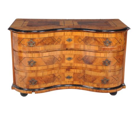  A South German walnut and strung commode  , second half 18th century, of serpentine outline and incorporating three long dra