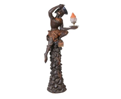  An Italian carved and stained wood figural stand modeled with an ape,   late 19th century and later refitted as standard lam