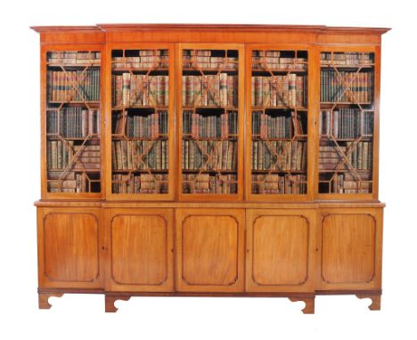  A George III mahogany breakfront library bookcase,   circa 1800, the moulded cornice above five astragal glazed doors openin