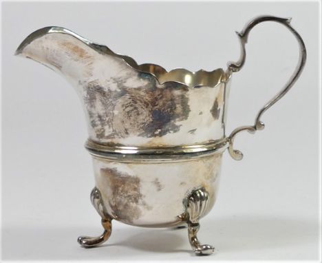 A silver helmet shape cream jug, Sheffield 1916, with shell capped paw legs, 8cm, 86gm 