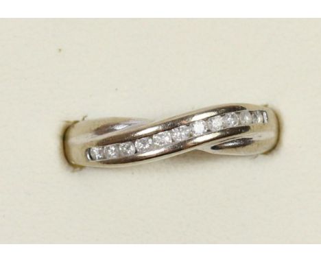 A 9ct white gold brilliant cut diamond channel set ring, O, 2.3gm 