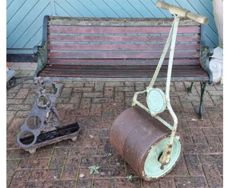 A cast metal and hardwood slat garden bench, 139cm, a wrought iron vintage The Gamage, Holborn garden roller and a cast iron 