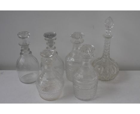 A selection of six glass decanters to include a pair of 19th century club-shaped decanters and stoppers each cut with a diamo