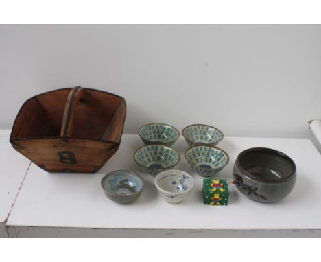 A quantity of stoneware and ceramic small glazed bowls to include rice bowls decorated with Chinese characters, a blue and br