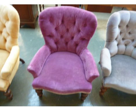 A 20th century Victorian style button back tub chair in purple material and turned legs