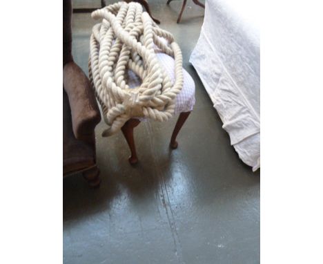 A 20th century oak armchair, with a stool in cheque upholstery, and a section of vintage rope