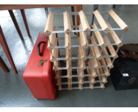 A wine rack, together with a vintage red suitcase 