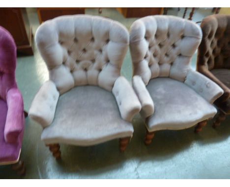 A pair of 20th century Victorian style button back tub chairs, in grey material and turned legs