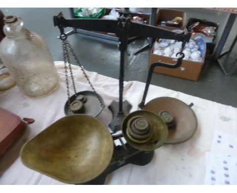 A set of vintage kitchen scales, with another set of scales, with weights