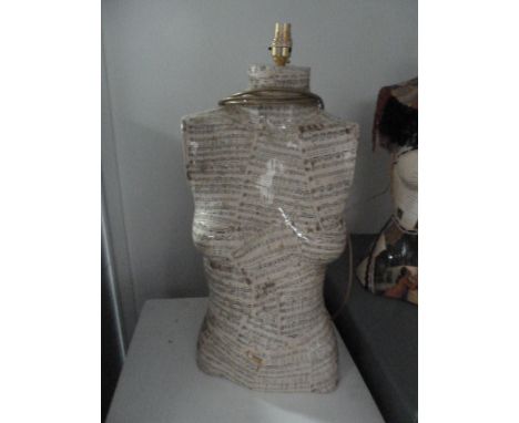 A half torso mannequin lamp decorated with sheet music 60cmH