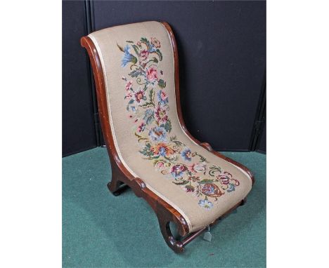 Victorian chair with floral tapestry upholstery.