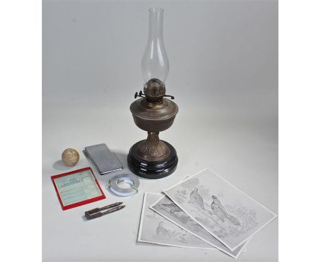 Oil lamp, together with a stone ball, a cigarette case, a tape measure a print and nut crackers, (7)