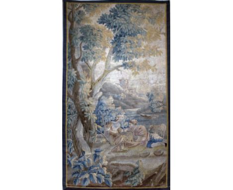 A fine 18th Century French polychrome Verdure Tapestry, with figures resting in a landscape, with castle beyond, (lined), 7'4