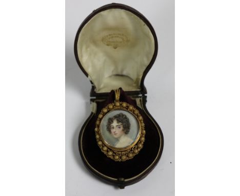 A 19th Century circular miniature Portrait, "A Lady," in gold frame, 2 1/2" (6cms) in fitted leather bound case. (1)