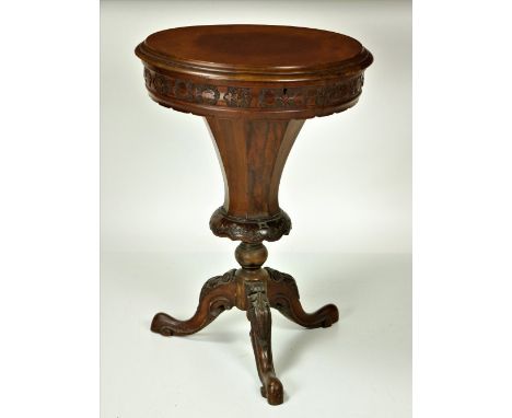 A Victorian walnut Ladies Sewing Table, the circular lift top opening to reveal a fitted interior on a carved tripod base. (1