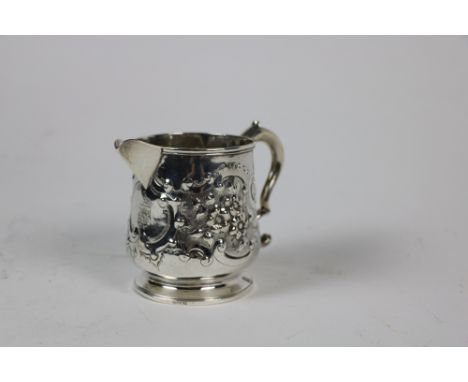 A silver Milk Jug, Dublin 1812, with "S" scroll handle, the body decorated with foliate design, cartouche to the front bearin