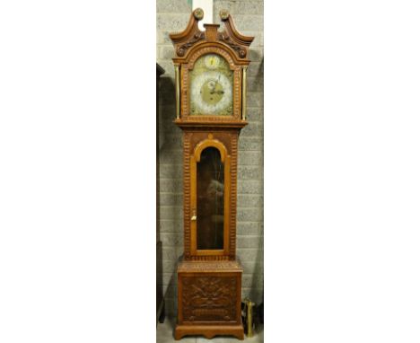 A 19th Century oak framed Grandfather Clock, the swan neck pediment with circular ormolu mounts over an arched brass and silv