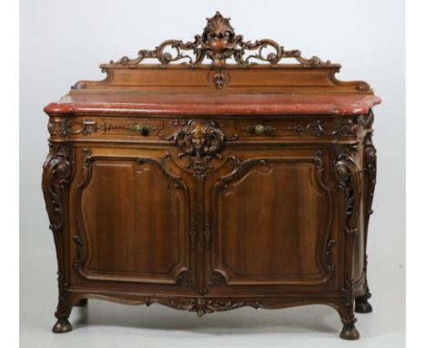 An attractive carved walnut Buffet, with rouge serpentine shaped marble top above a double panel frieze drawer with central c