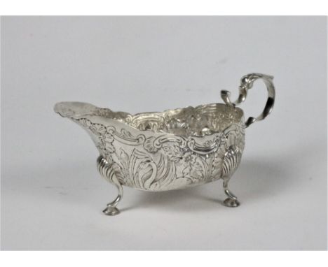 An attractive 19th Century Irish silver Sauceboat, Dublin c. 1899, decorated in repoussé design, depicting swans and foliage,