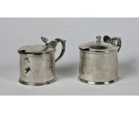 A Victorian silver Mustard Pot, with hinged lid and scroll handle and blue liner, London "S.C.", and another similar Georgian