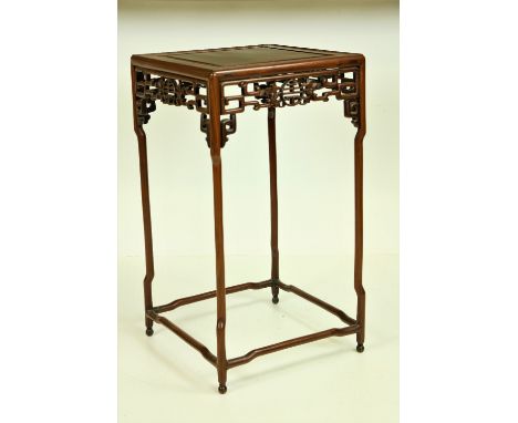 An Oriental tall hardwood Table, of square shape, the panelled top over a typical Chinese fretwork frieze, on spider type leg