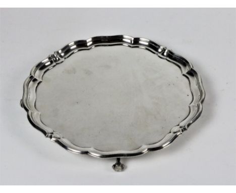 A large 19th Century Sheffield silver Salver, with shaped rim on four scroll feet, approx. 31cms (12") diameter, approx. 28 o