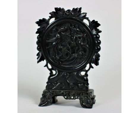 A very unusual Chinese carved black hard stone Table Screen, the circular centre panel carved with dragon and phoenix in high