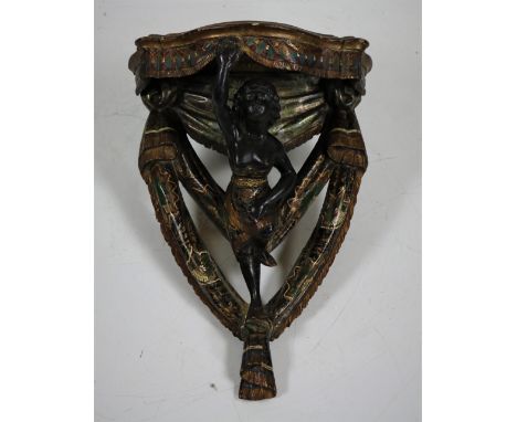 A good quality 19th Century polychrome and parcel gilt Blackamoor wall mounted Console Bracket, with semi clad black female a