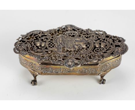 An attractive pierced decorated silver shaped Box, designed with horse drawn carriage, bells, angels etc., on paw feet by Wil