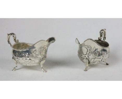 A George III Irish silver Sauceboat, c. 1780, Dublin by Matthew West, the overall body embossed with animals and flowers, cre