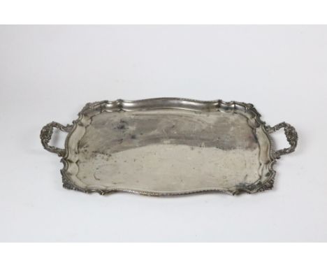 A very heavy two handled silver Tray, of shaped rectangular form, with shell decorated handles, and shaped edge, Sheffield c.