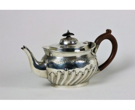 An attractive Georgian style silver Teapot, of oval format, London c. 1903, with wooden handle, approx. 28cms long, approx. 1